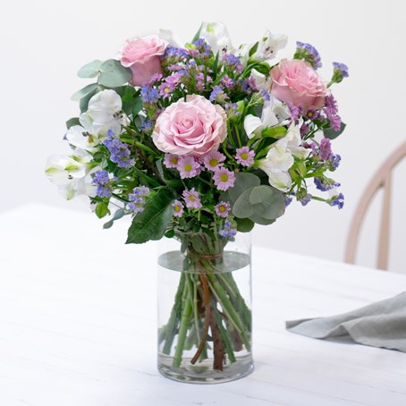 Bouquet of roses and mixed flowers with decorative greenery